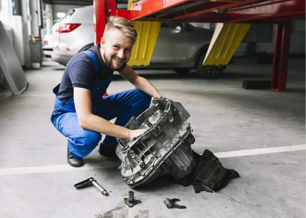 Mechanic with a removed transmission in the repair shop, fleet transmission maintenance in Ontario