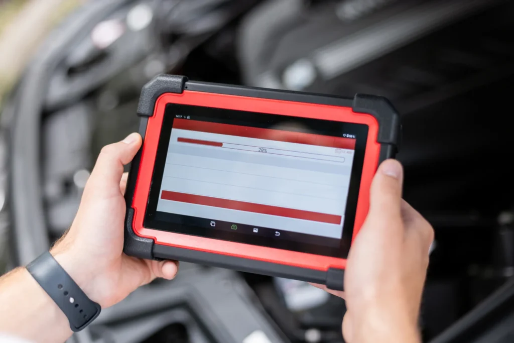 Technician using a diagnostic scanner to read transmission fault codes