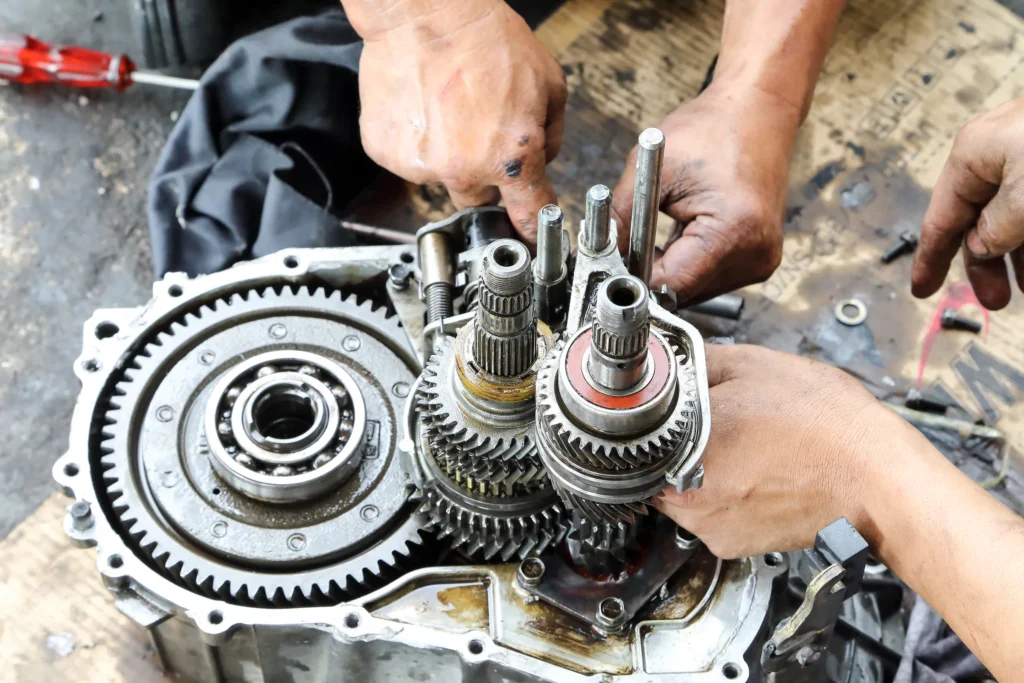 Technician rebuilding a gearbox with new gears and bearings