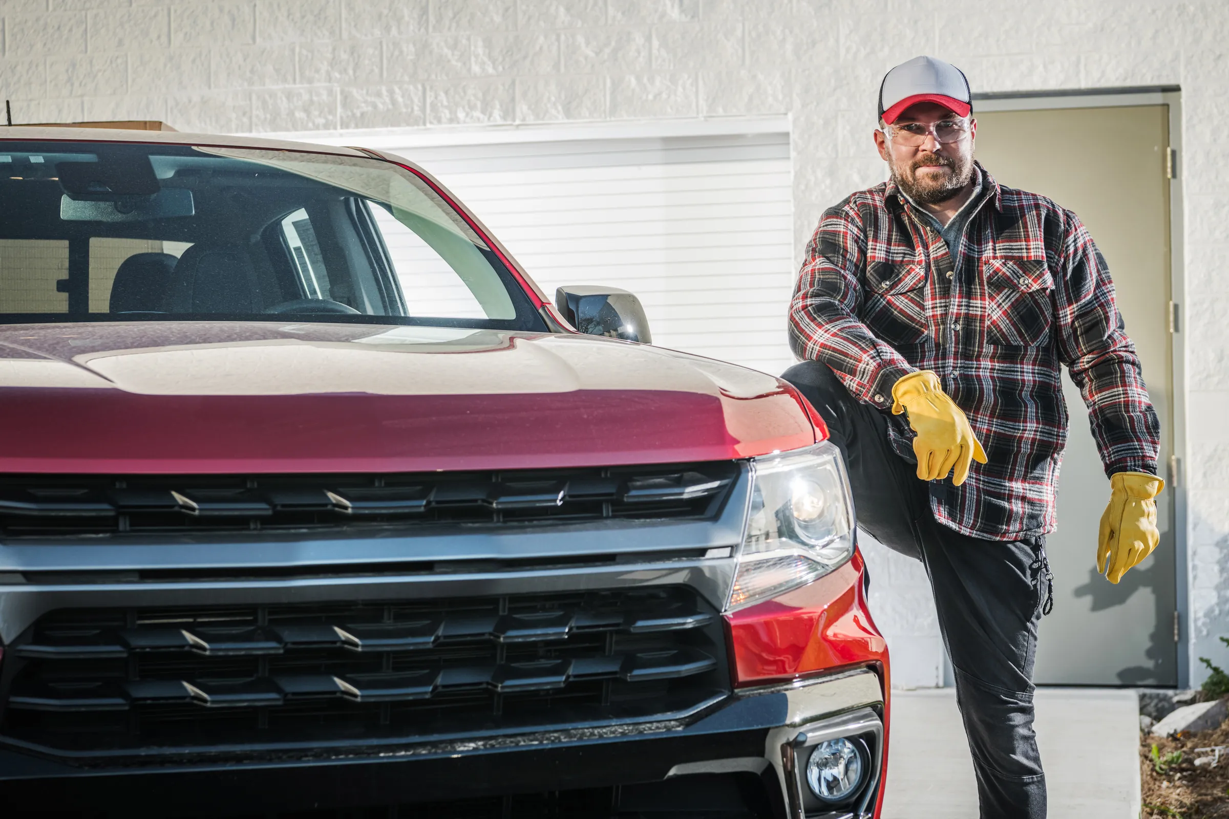 Mechanic beside a pickup truck at a truck and fleet transmission shop
